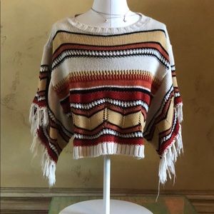 Knit fringe poncho arm sweater